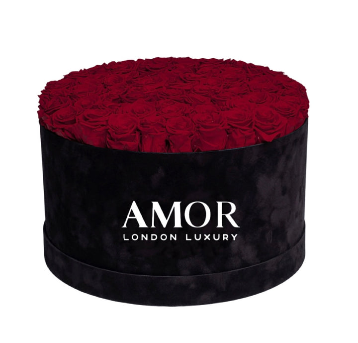 60-70 roses in a black round deluxe suede box.